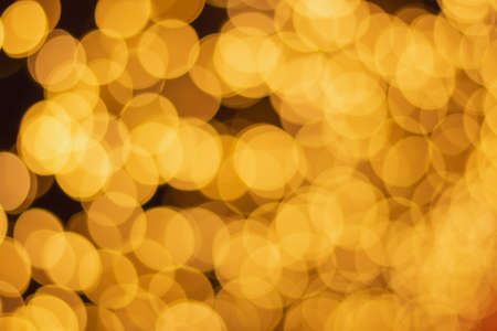 Golden and multicolored bokeh circle background for christmas and happy new year with space to display messagesの写真素材