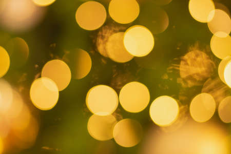 Golden and multicolored bokeh circle background for christmas and happy new year with space to display messagesの写真素材