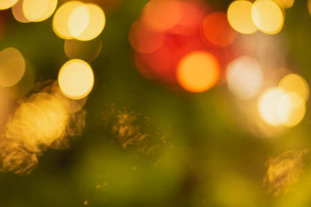 Golden and multicolored bokeh circle background for christmas and happy new year with space to display messagesの写真素材