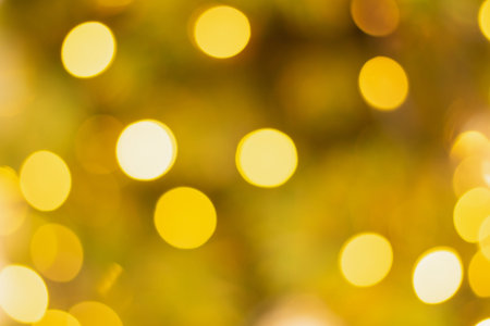 Golden and multicolored bokeh circle background for christmas and happy new year with space to...