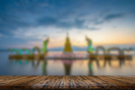 Empty wooden table on beautiful lake sunsetの写真素材