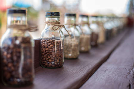 Rows of coffee in glass bottles Concept of different types of coffeeの写真素材
