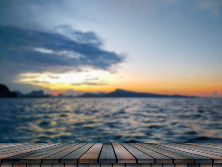 Empty wooden table on beautiful blurred sea sunset