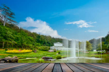 wooden table top on blurred park backgroundの写真素材