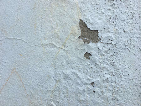 Old wall with decayed plaster cement and peeling texture background of cement color wallpaperの写真素材