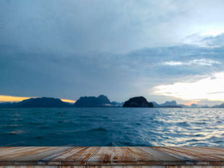 Empty wooden table on beautiful blurred sea sunsetの写真素材