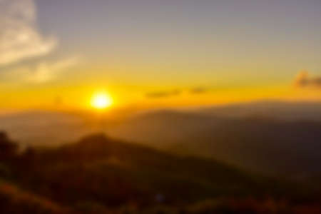 The blurred view of the mountains against the beautiful backdrop of the colored sky and clouds.の写真素材