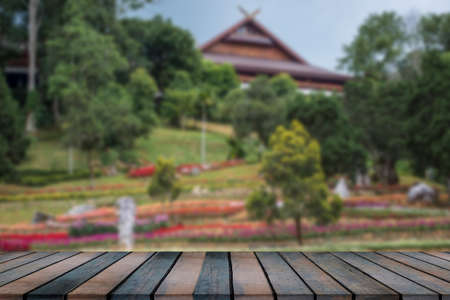 wooden table top on blurred park backgroundの写真素材