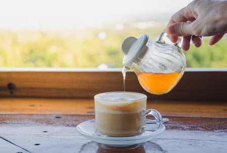 Pour the honey into the coffee cup.の写真素材