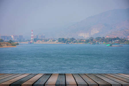 wooden table on empty on blurry riverの写真素材