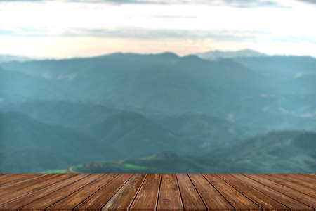 wooden table and beauty blur sky and mountains as backgroundの写真素材