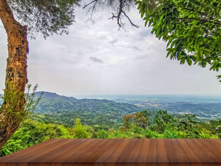 wooden table and beauty blur sky and mountains as backgroundの写真素材