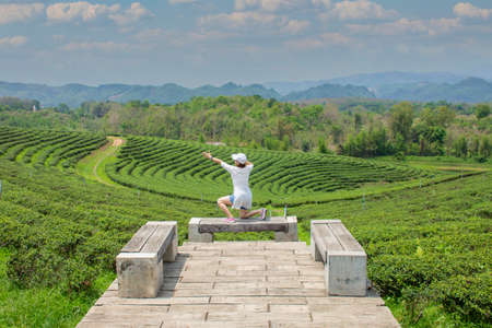 happy and free girl on the mountain on the tea plantationの写真素材