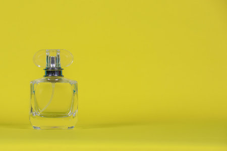 perfume bottle
laid on a yellow background with copy space for designの写真素材