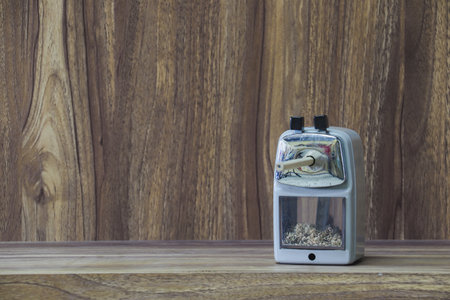 stapler placed on wooden table with copy space for vintage style wood grain background designの写真素材