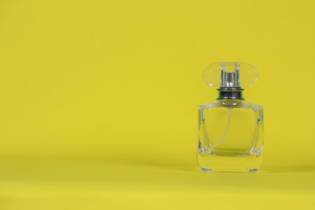perfume bottle
laid on a yellow background with copy space for designの写真素材
