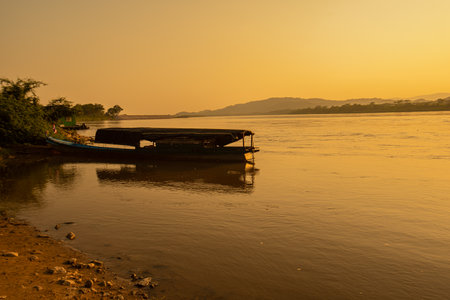 Boat on the Mekong River at sunset in Laos, Asiaの写真素材