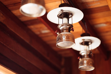 Vintage lamp hanging on the ceiling of a wooden house. Selective focusの写真素材