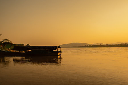 Boat on the Mekong River at sunset in Laos. The Mekong River is the longest river in Laos.の写真素材