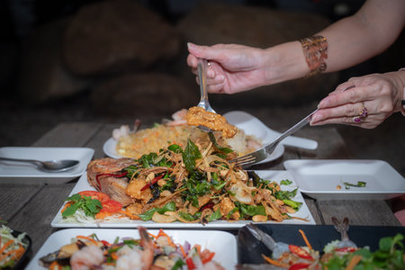 Fried noodle with shrimp in thai style on wooden tableの写真素材