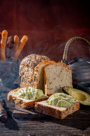 Bread with avocado and sesame seeds on a wooden table.の写真素材