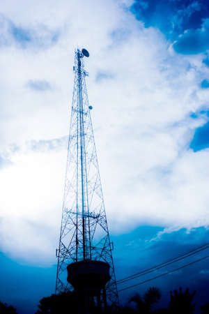 Silhouette of transmitter tower with blue sky の写真素材