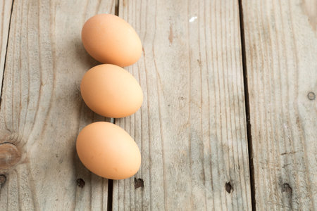 three eggs on wooden table