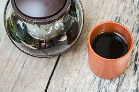 black tea in kettle and Clay cupsの写真素材