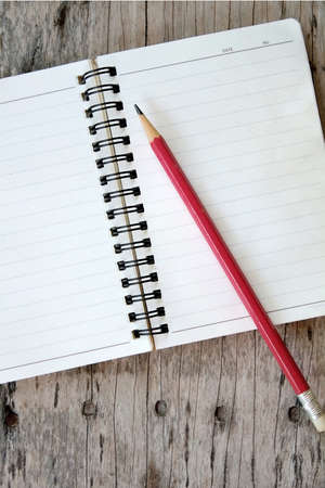 notebook and pencil on old wooden backgroundの写真素材