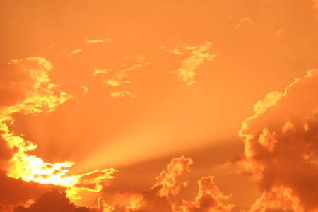 Rays of light shining through dark clouds for backgroundの写真素材