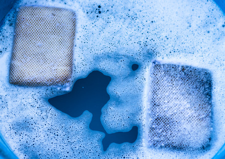 Dishwashing sponge two cubes Is washing dishes in a restaurant in Thailand.の写真素材