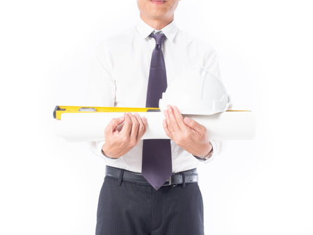 Portrait asia construction engineer handsome man white shirt black pants holding helmet and blueprints isolated on whiteの写真素材