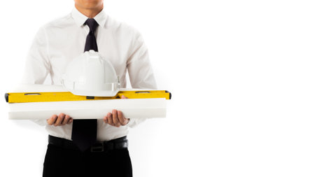 Portrait asia construction engineer handsome man white shirt black pants holding helmet and blueprints isolated on whiteの写真素材