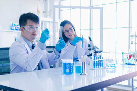 Asian scientists use scientific experiment equipmentà¹Science medical phamasutical medicine lab in hospital. scientist doing some research vaccine anti virus sample.の写真素材