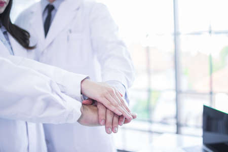 Group of professional asia doctors holding hands together in hospitalの写真素材