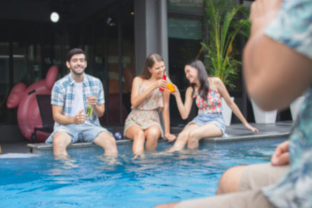 multiethnic People dancing and having a good time at an evening party by the poolの写真素材