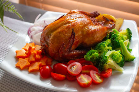 Roasted Chicken with Tomatoes, Vegetables, Broccoli and Carrot...の写真素材