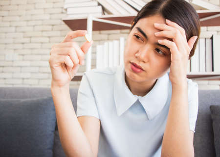senior man at the nursing home concept. concept.woman looked unhappy at the pill in her hand.の写真素材
