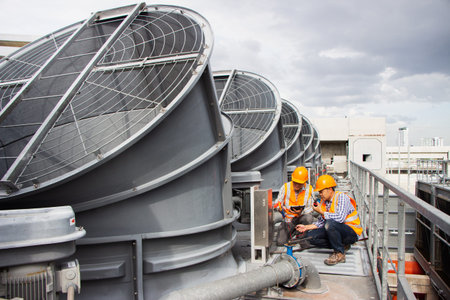 Asian male engineer inspecting pipe fittings and chillers, refrigeration plant refrigeration plant...