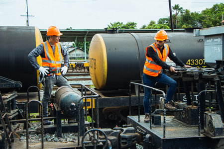 Inspector Engineering wearing helmet and vest worker unifrom checking railway construction work on...