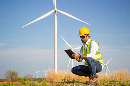 engineer team working in wind turbine farm. Renewable energy with wind generator by alternative energy concept.の写真素材