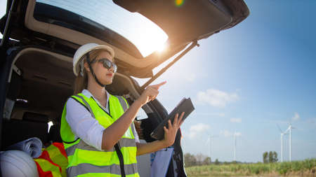 engineer team working in wind turbine farm. Renewable energy with wind generator by alternative energy concept.の写真素材