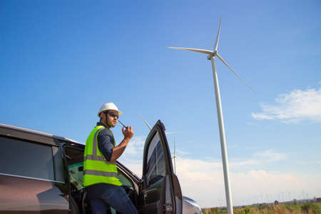 engineer team working in wind turbine farm. Renewable energy with wind generator by alternative energy concept.の写真素材