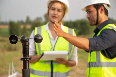 engineer team working in wind turbine farm. Renewable energy with wind generator by alternative energy concept.の写真素材
