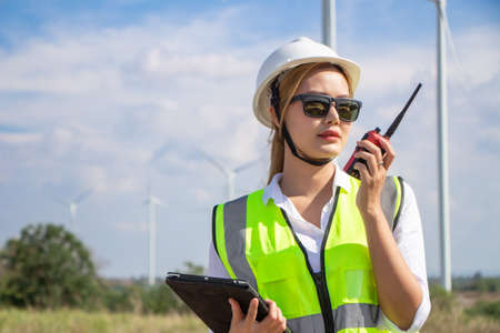 engineer team working in wind turbine farm. Renewable energy with wind generator by alternative energy concept.の写真素材