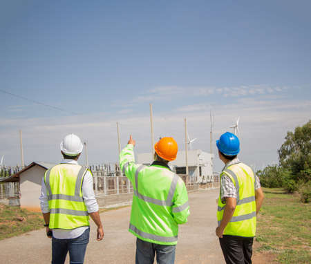 engineer team working in wind turbine farm. Renewable energy with wind generator by alternative energy concept.の写真素材