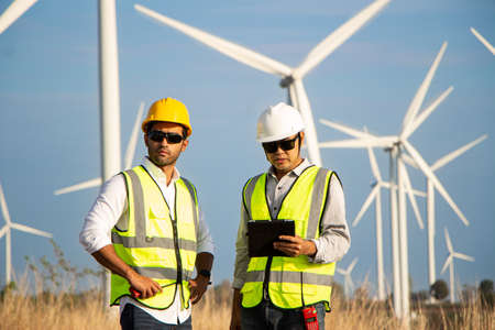 engineer team working in wind turbine farm. Renewable energy with wind generator by alternative energy concept.の写真素材