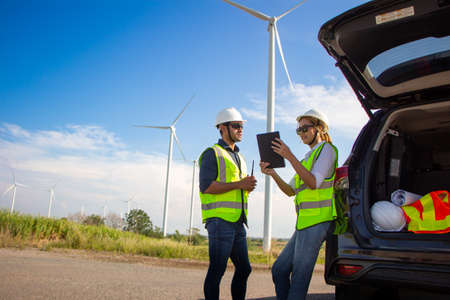 engineer team working in wind turbine farm. Renewable energy with wind generator by alternative energy concept.の写真素材