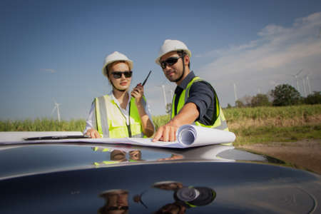 engineer team working in wind turbine farm. Renewable energy with wind generator by alternative energy concept.の写真素材