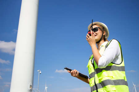 engineer team working in wind turbine farm. Renewable energy with wind generator by alternative energy concept.の写真素材
